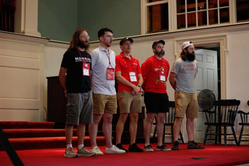 a group of men standing on a stage