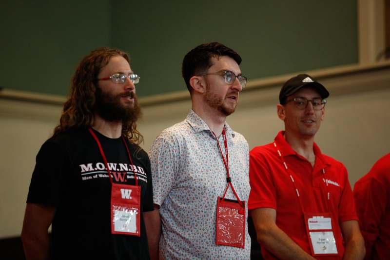 a group of men wearing lanyards