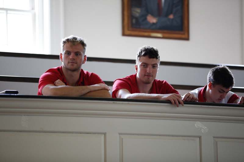 a group of men in red shirts