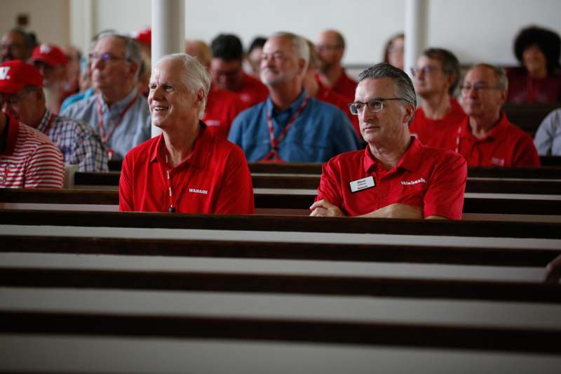 a group of people sitting in pews