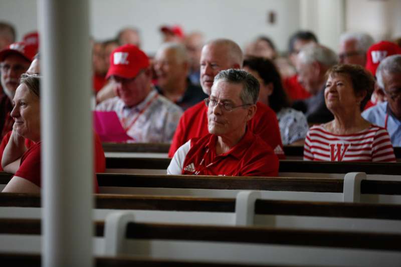a group of people sitting in pews