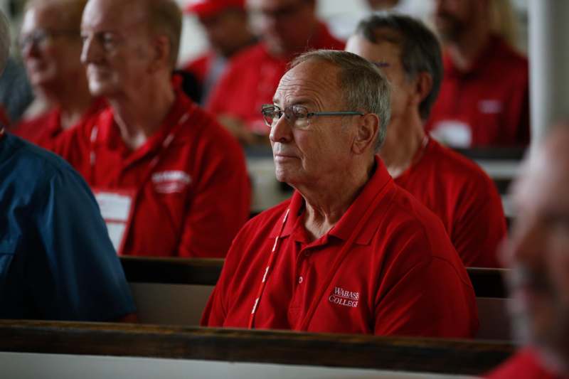 a group of men in red shirts