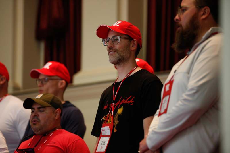 a group of men wearing red hats
