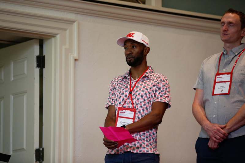 a man holding a pink piece of paper