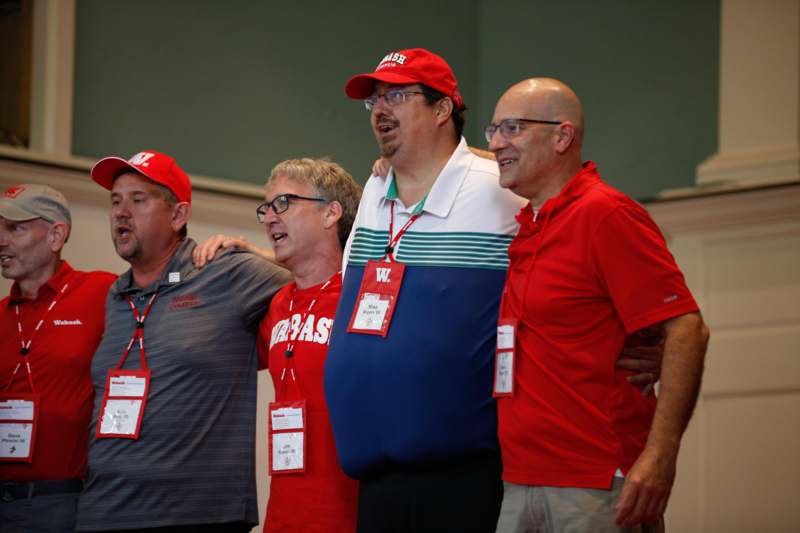 a group of men wearing red shirts