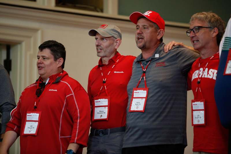 a group of men wearing red shirts