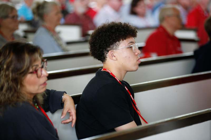 a man and woman sitting in pews