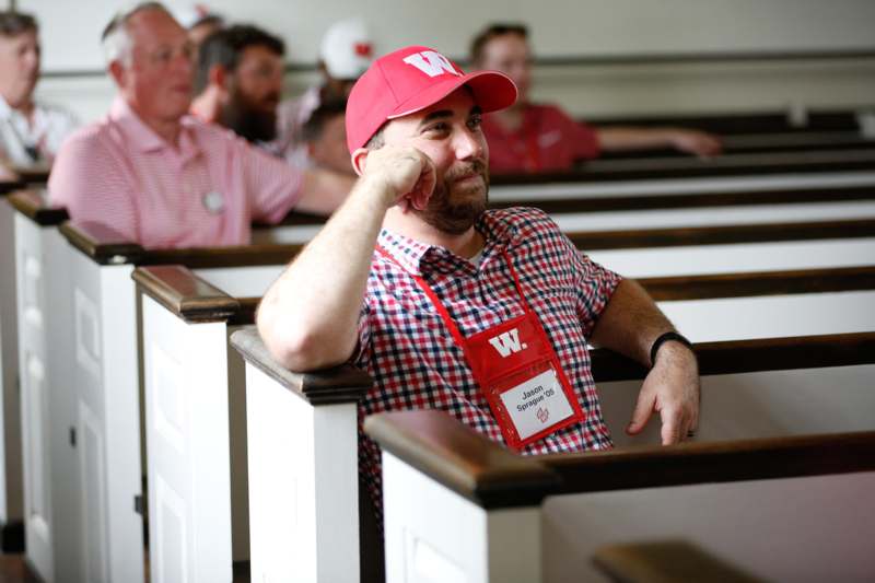 a man in a red hat and a badge