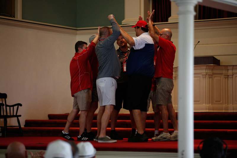 a group of men giving each other high five