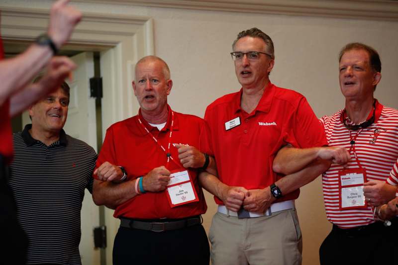 a group of men wearing red shirts