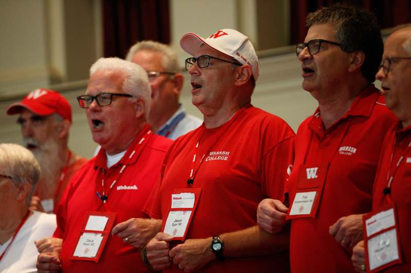 a group of men wearing red shirts