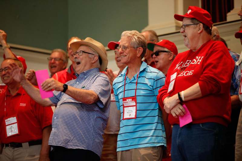 a group of men in red shirts