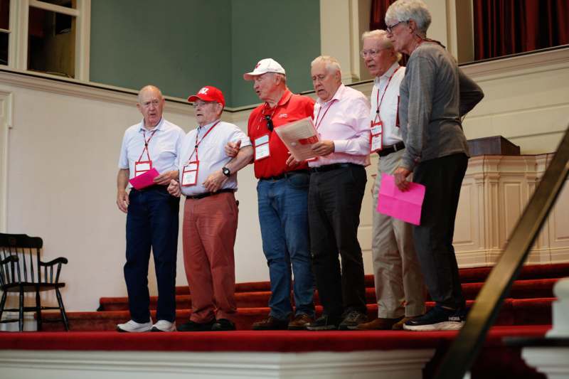 a group of men standing on a red carpet
