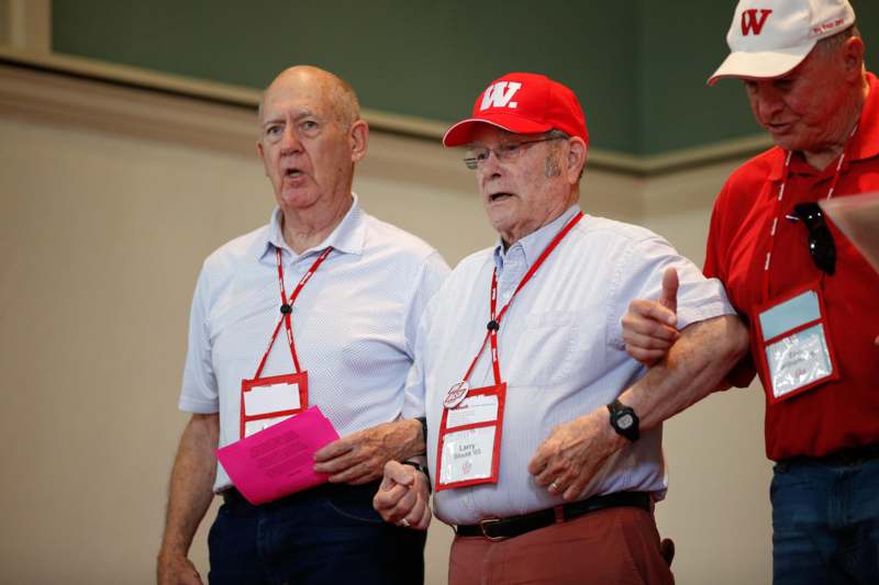 a group of men wearing lanyards and badges