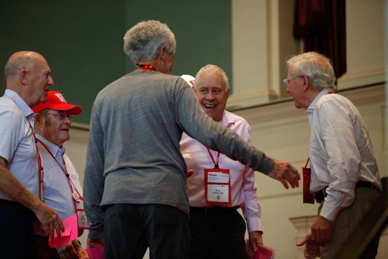 a group of older men laughing