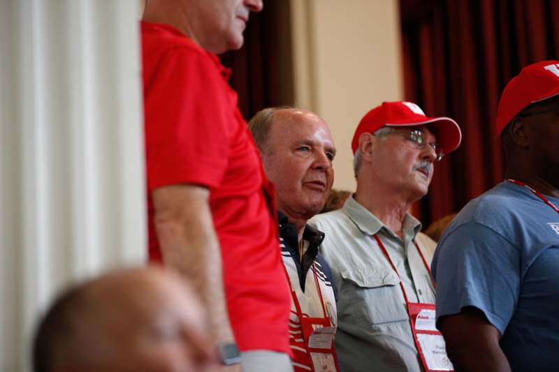 a group of men wearing red shirts