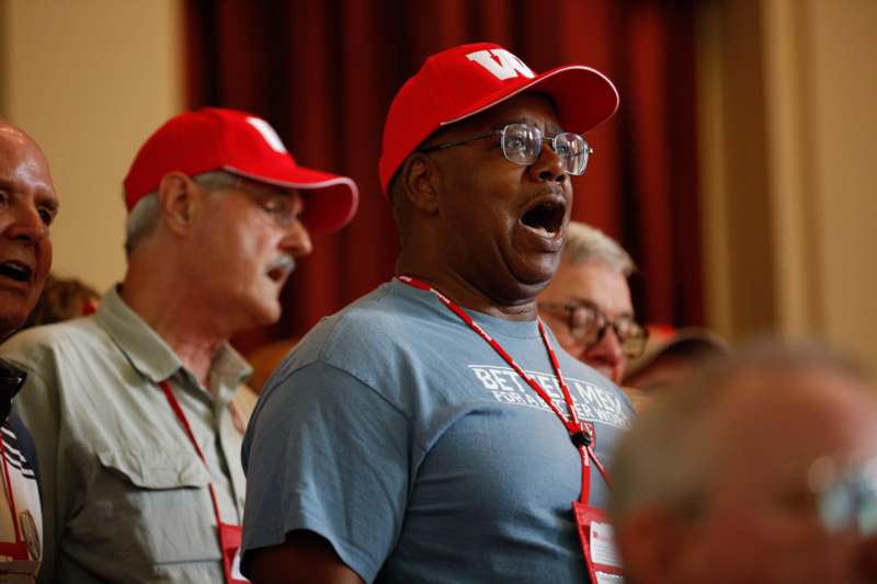 a group of men wearing red hats