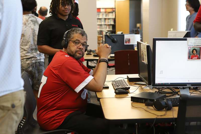 a man sitting at a desk with a computer