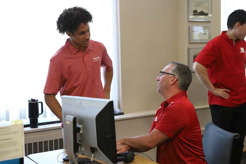 a group of men in red shirts