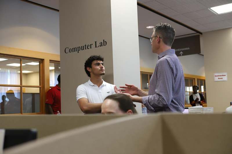 a man talking to another man