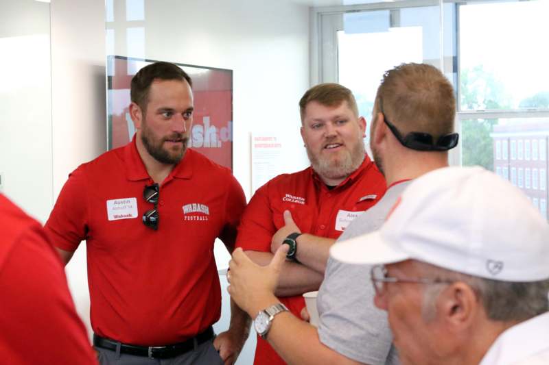 a group of men in red shirts