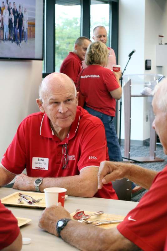 a group of people in red shirts