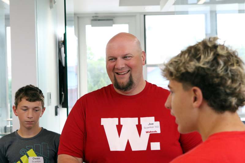a man in a red shirt with a white w on it