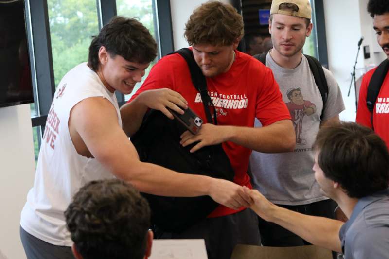 a group of men holding a phone