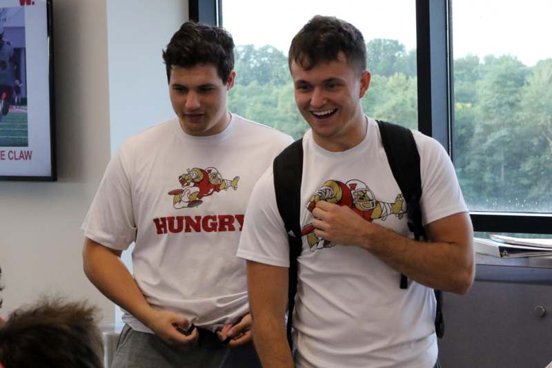 two men wearing white shirts