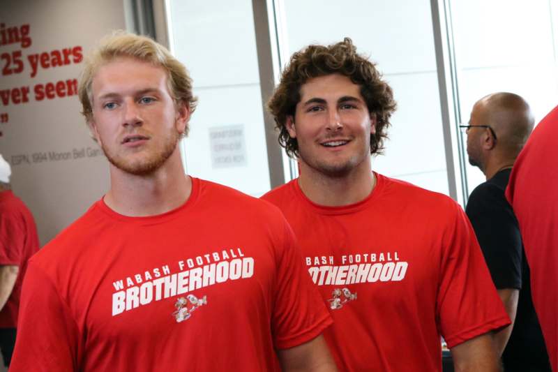 two men wearing red shirts