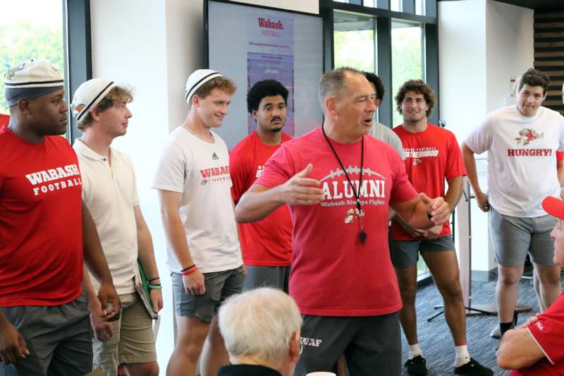 a group of men in red shirts