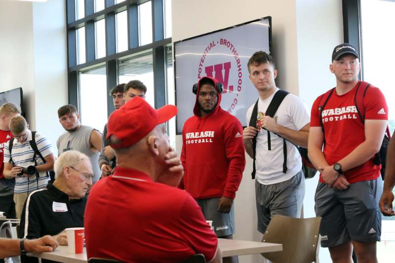 a group of men in red shirts