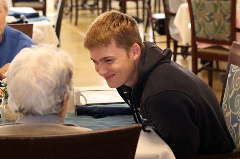 a man sitting at a table with an older man