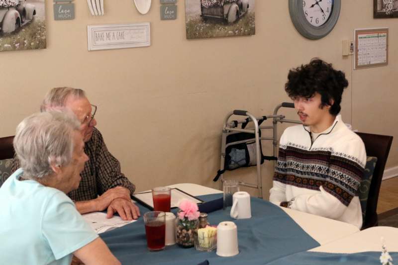a group of people sitting around a table