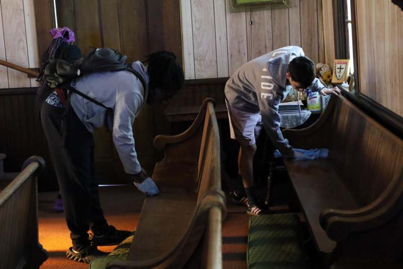 a group of people cleaning benches