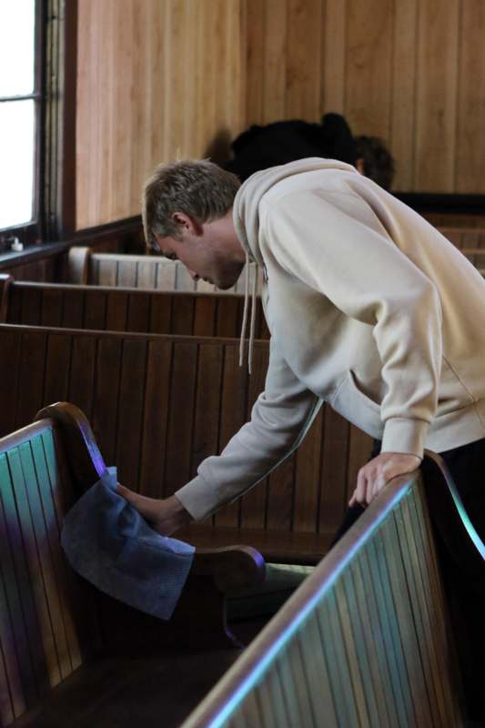 a man wiping a bench