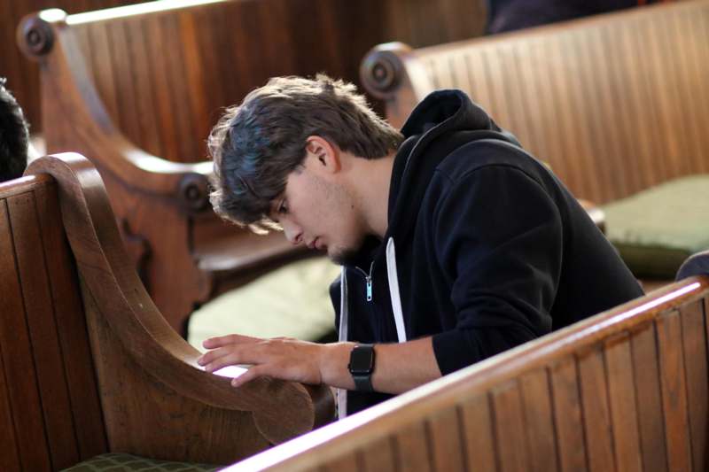 a man sitting in a church pew