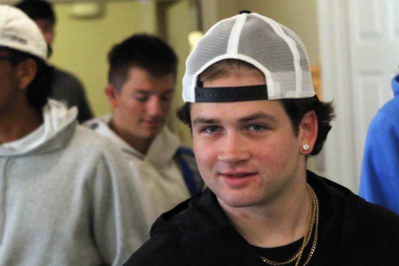 a man wearing a white and black hat