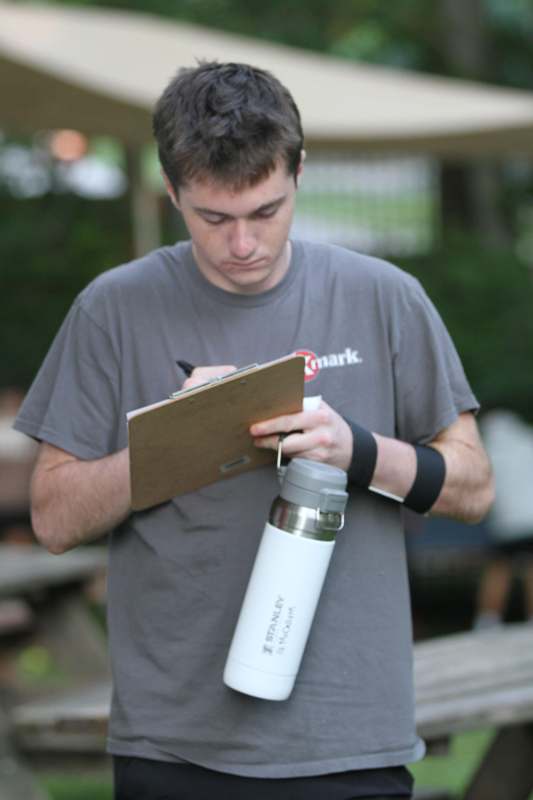 a man writing on a clipboard