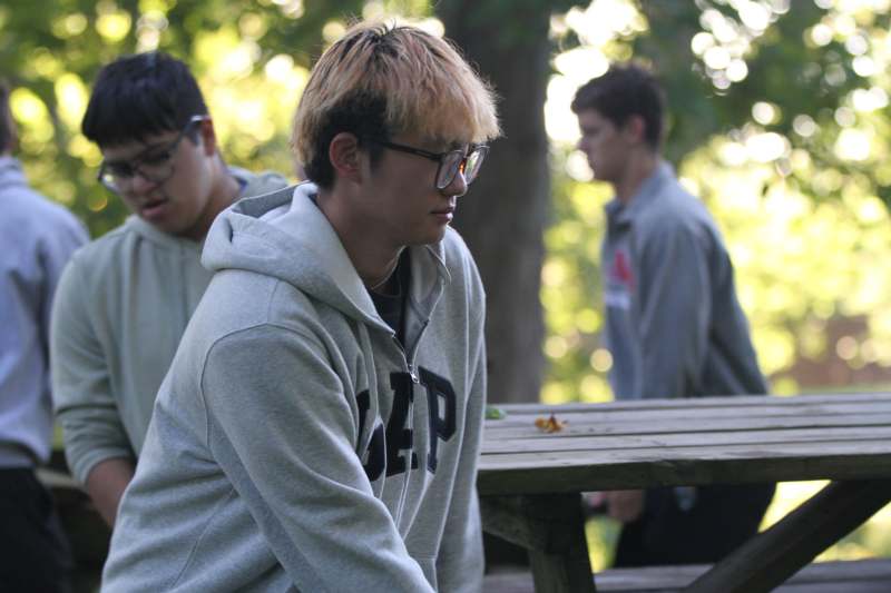 a group of men sitting at a picnic table