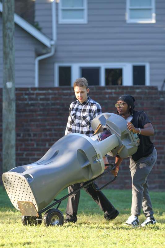 a group of people pushing a large object