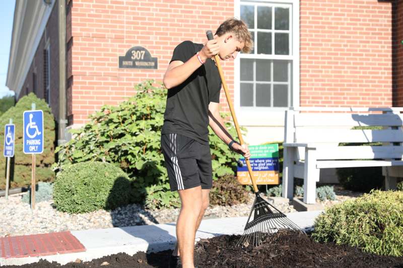 a man holding a rake