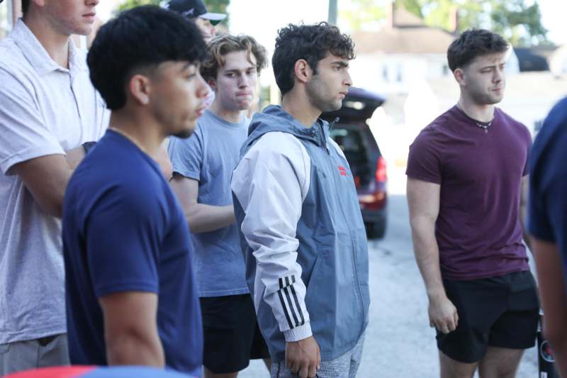 a group of men standing on a street
