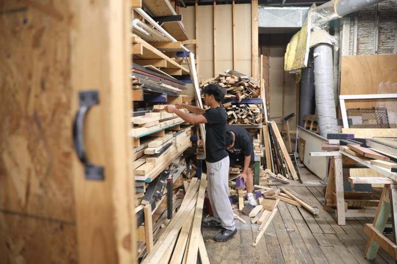 a group of people working in a wood shop