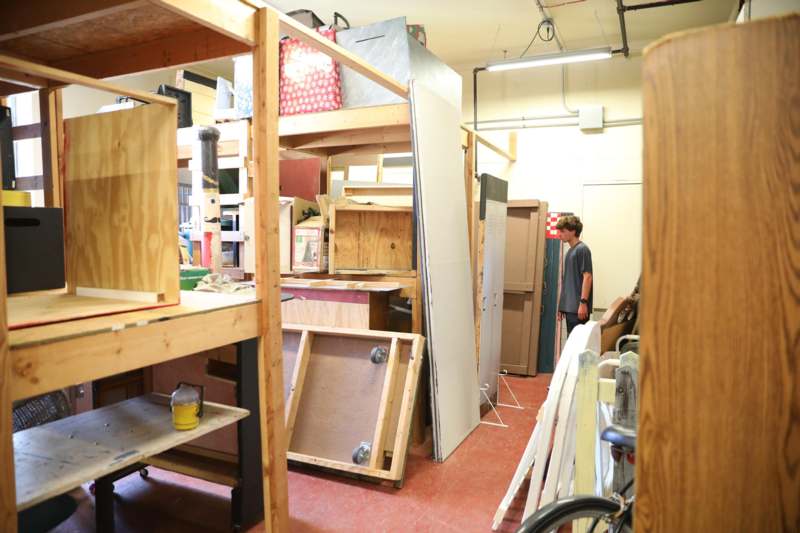 a man standing in a room with wood shelves