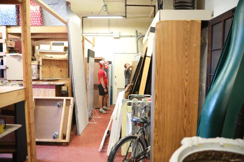 a man looking at a man in a room with wood and wood