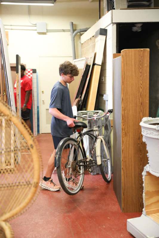 a man holding a bicycle
