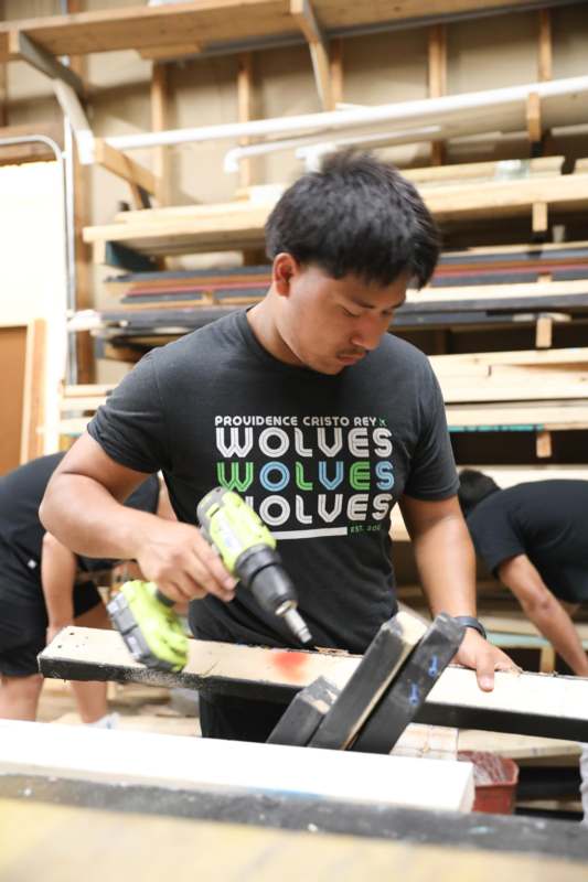 a man using a drill to drill wood