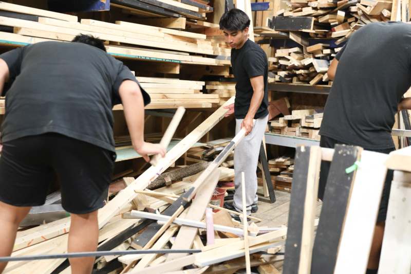a group of men working in a room with wood