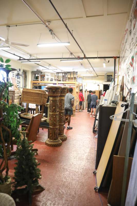 people inside a store with many objects